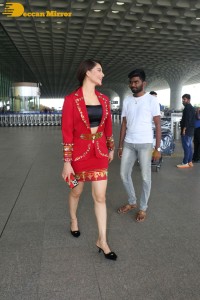 Actress Urvashi Rautela is seen at Mumbai Airport dressed in a red coat and skirt