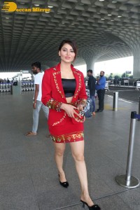 Actress Urvashi Rautela is seen at Mumbai Airport dressed in a red coat and skirt