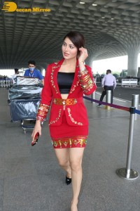 Actress Urvashi Rautela is seen at Mumbai Airport dressed in a red coat and skirt