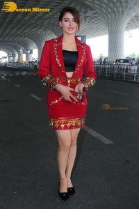 Actress Urvashi Rautela is seen at Mumbai Airport dressed in a red coat and skirt