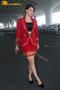 Actress Urvashi Rautela is seen at Mumbai Airport dressed in a red coat and skirt