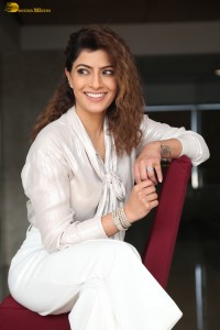 actress Varalaxmi Sarathkumar stylish looks in a white dress