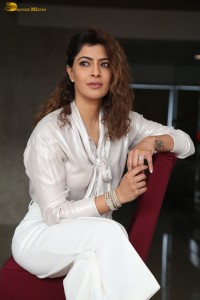 actress Varalaxmi Sarathkumar stylish looks in a white dress