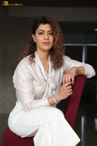 actress Varalaxmi Sarathkumar stylish looks in a white dress