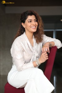 actress Varalaxmi Sarathkumar stylish looks in a white dress