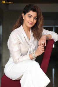 actress Varalaxmi Sarathkumar stylish looks in a white dress