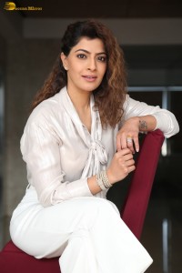 actress Varalaxmi Sarathkumar stylish looks in a white dress