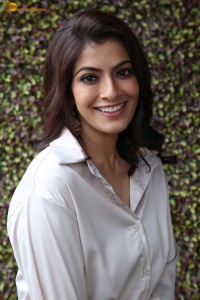 Varalaxmi Sarathkumar sexy looks in a white shirt and red skirt