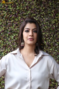 Varalaxmi Sarathkumar sexy looks in a white shirt and red skirt