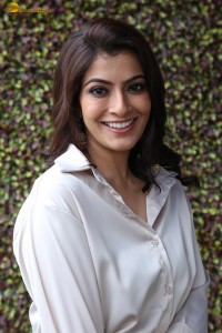 Varalaxmi Sarathkumar sexy looks in a white shirt and red skirt