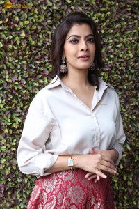 Varalaxmi Sarathkumar sexy looks in a white shirt and red skirt