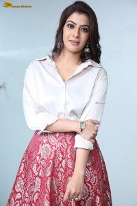 Varalaxmi Sarathkumar sexy looks in a white shirt and red skirt
