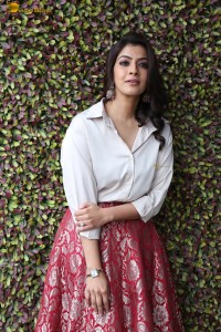 Varalaxmi Sarathkumar sexy looks in a white shirt and red skirt