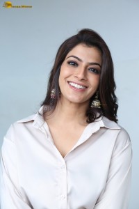 Varalaxmi Sarathkumar sexy looks in a white shirt and red skirt