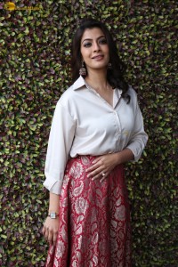 Varalaxmi Sarathkumar sexy looks in a white shirt and red skirt