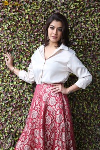 Varalaxmi Sarathkumar sexy looks in a white shirt and red skirt