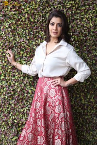 Varalaxmi Sarathkumar sexy looks in a white shirt and red skirt