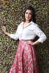 Varalaxmi Sarathkumar sexy looks in a white shirt and red skirt