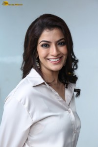 Varalaxmi Sarathkumar sexy looks in a white shirt and red skirt