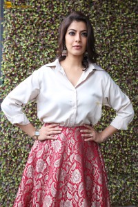 Varalaxmi Sarathkumar sexy looks in a white shirt and red skirt