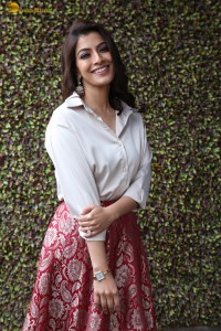 Varalaxmi Sarathkumar sexy looks in a white shirt and red skirt