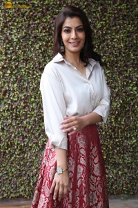 Varalaxmi Sarathkumar sexy looks in a white shirt and red skirt