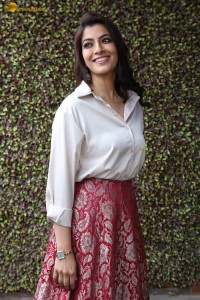 Varalaxmi Sarathkumar sexy looks in a white shirt and red skirt