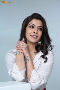 Varalaxmi Sarathkumar sexy looks in a white shirt and red skirt