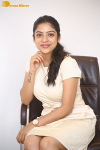 Telugu Actress Varsha Bollamma in a white dress