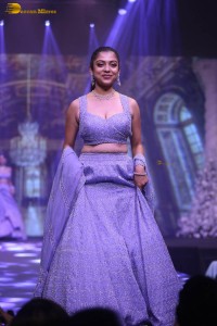 actress varsha bollamma ramp walk in a purple lehenga choli