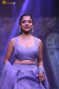 actress varsha bollamma ramp walk in a purple lehenga choli