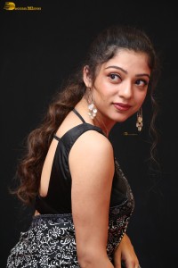 actress Varsha Bollamma cute in a black and white saree