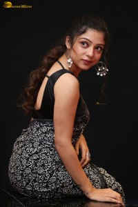 actress Varsha Bollamma cute in a black and white saree