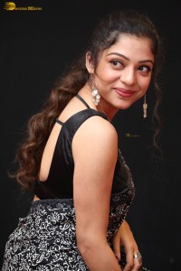 actress Varsha Bollamma cute in a black and white saree