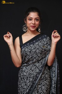 actress Varsha Bollamma cute in a black and white saree