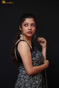 actress Varsha Bollamma cute in a black and white saree