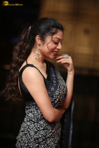 actress Varsha Bollamma cute in a black and white saree