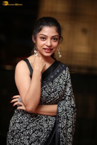 actress Varsha Bollamma cute in a black and white saree