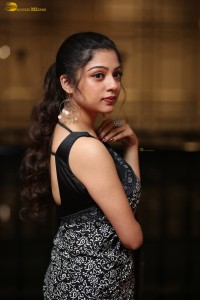 actress Varsha Bollamma cute in a black and white saree