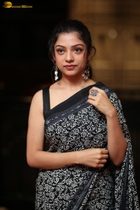 actress Varsha Bollamma cute in a black and white saree