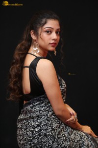 actress Varsha Bollamma cute in a black and white saree