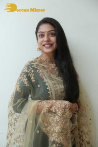 Varsha Bollamma photoshoot in a dark green salwar kameez