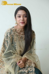 Varsha Bollamma photoshoot in a dark green salwar kameez