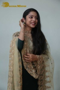 Varsha Bollamma photoshoot in a dark green salwar kameez