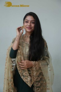 Varsha Bollamma photoshoot in a dark green salwar kameez