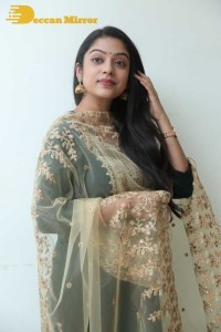 Varsha Bollamma photoshoot in a dark green salwar kameez