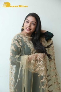 Varsha Bollamma photoshoot in a dark green salwar kameez