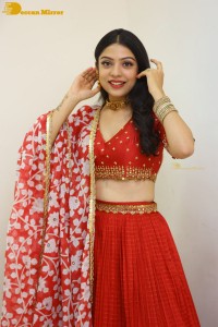Indian Actress Varsha Bollamma in a red dress