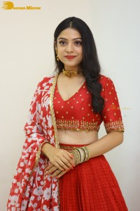 Indian Actress Varsha Bollamma in a red dress