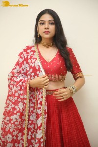 Indian Actress Varsha Bollamma in a red dress
